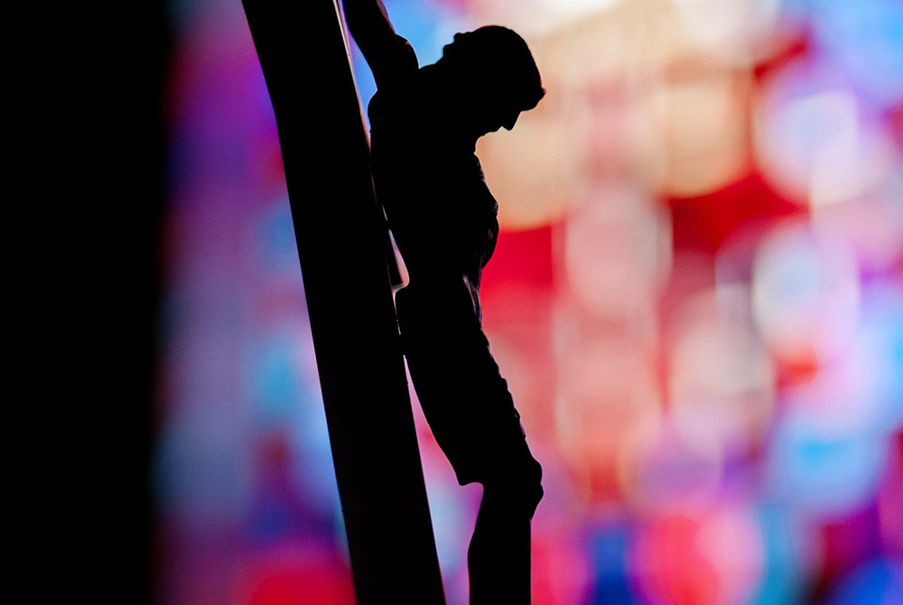 A crucifix is silhouetted against a stained-glass window in this illustration photo. (CNS/Mike Crupi, Catholic Courier) A crucifix is silhouetted against a stained-glass window in this illustration photo. (CNS/Mike Crupi, Catholic Courier)