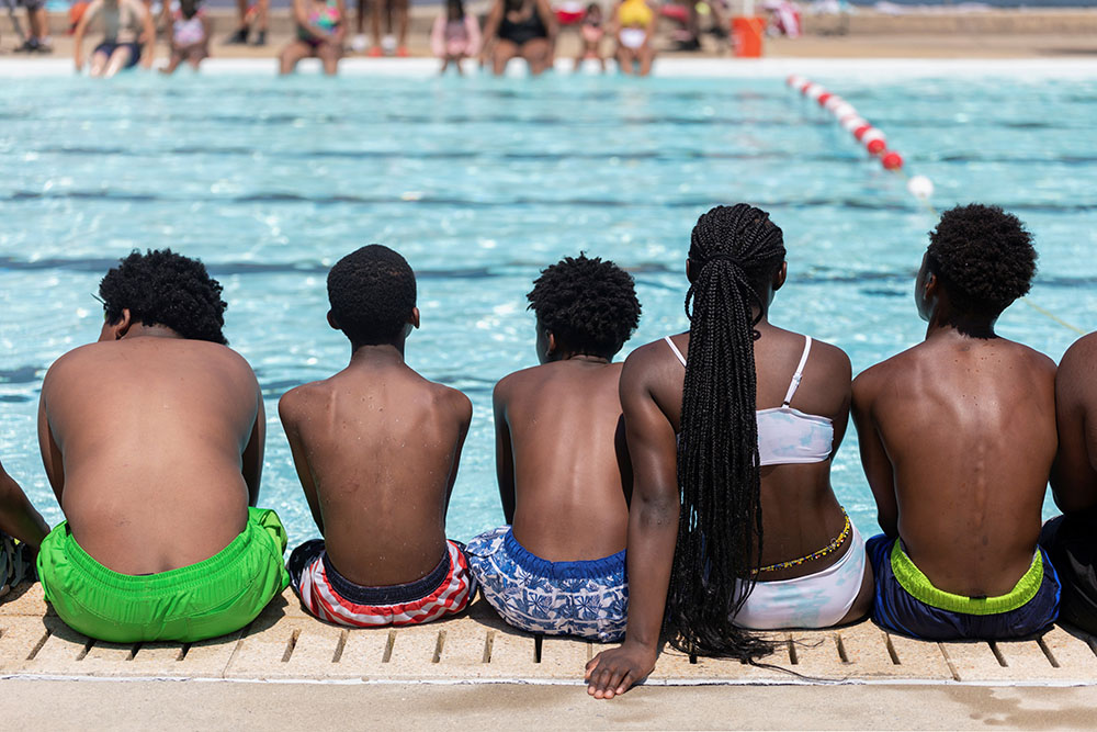 People in Philadelphia wait to swim at the opening of James Finnegan Playground's pool June 30, amid a heat wave. (CNS/Reuters/Hannah Beier)