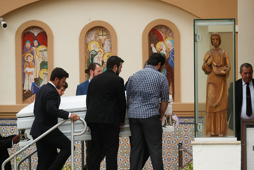 Pallbearers carry the casket of a Guara family member during a funeral Mass at St. Joseph Catholic Church in Miami Beach July 6.
