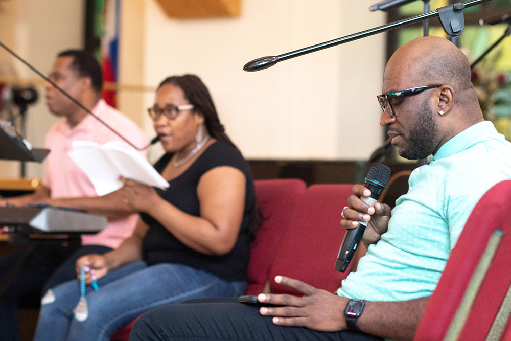 Choir members pray at Notre Dame d'Haiti Mission in Miami during a eucharistic adoration and afternoon prayer vigil for Haiti July 7. Earlier that day, President Jovenel Moïse of Haiti was assassinated in Port-au-Prince. (CNS/Florida Catholic/Tom Tracy)