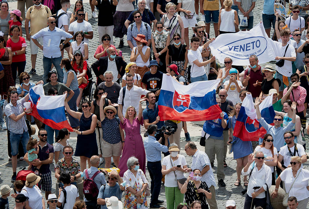 Pilgrims holding the Slovak flag cheer in St. Peter's Square at the Vatican July 4, 2021, as Pope Francis announces he will visit their country Sept. 12-15. (CNS/Vatican Media)