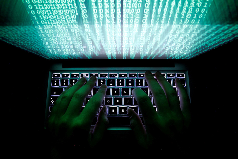 Computer keyboard photo illustration A man types on a computer keyboard in this illustration photo. (CNS/Reuters/Kacper Pempel)