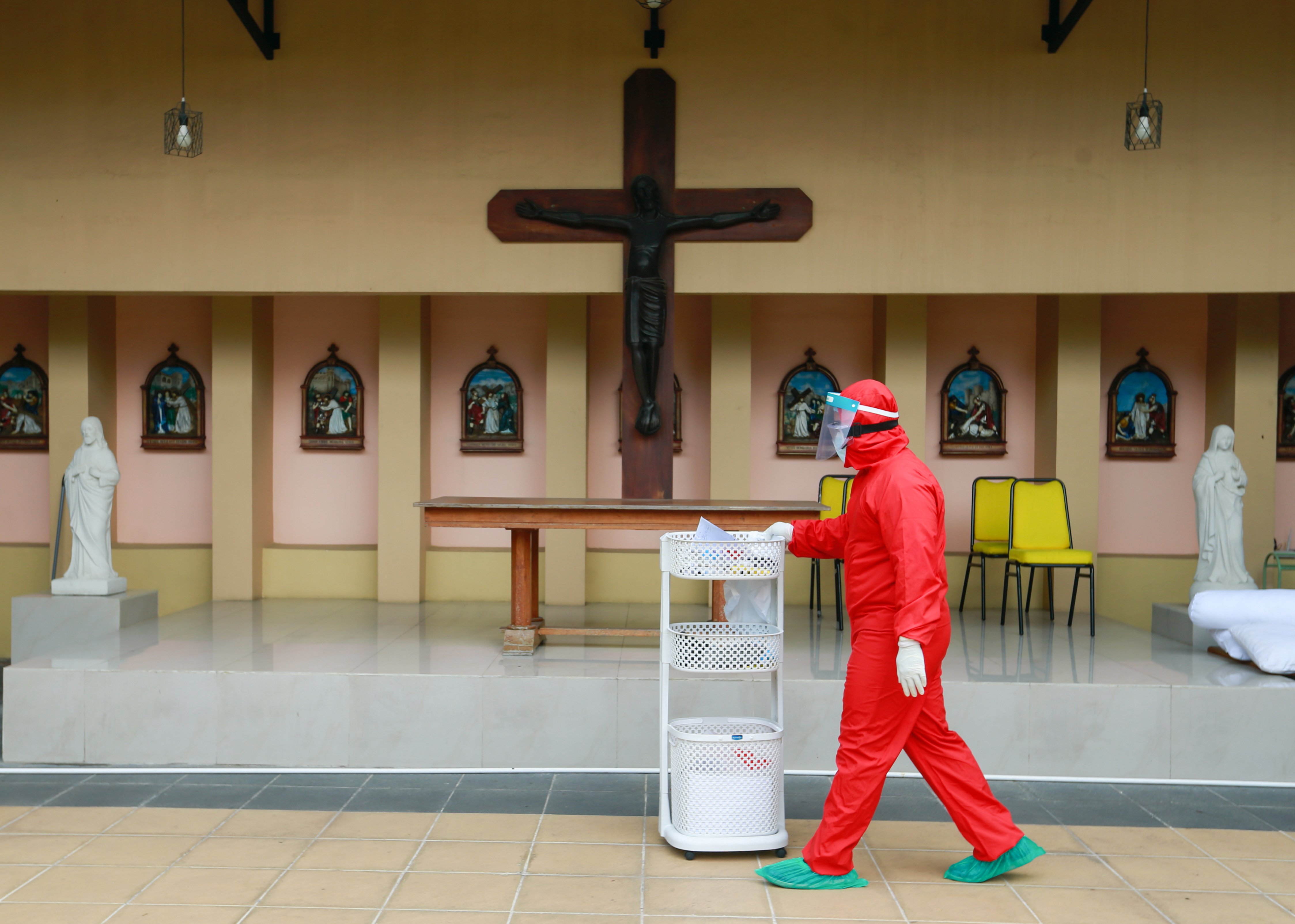 A health care makes rounds at a Catholic church training center turned into a self-isolation shelter for COVID-19 patients in Jakarta, Indonesia, July 22, 2021. (CNS photo/Ajeng Dinar Ulfiana, Reuters)