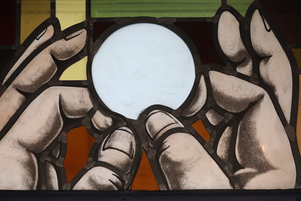 Elevation of the Eucharist is depicted in a stained-glass window Elevation of the Eucharist is depicted in a stained-glass window at St. Anthony's Church July 15 in North Beach, Maryland. (CNS/Bob Roller)