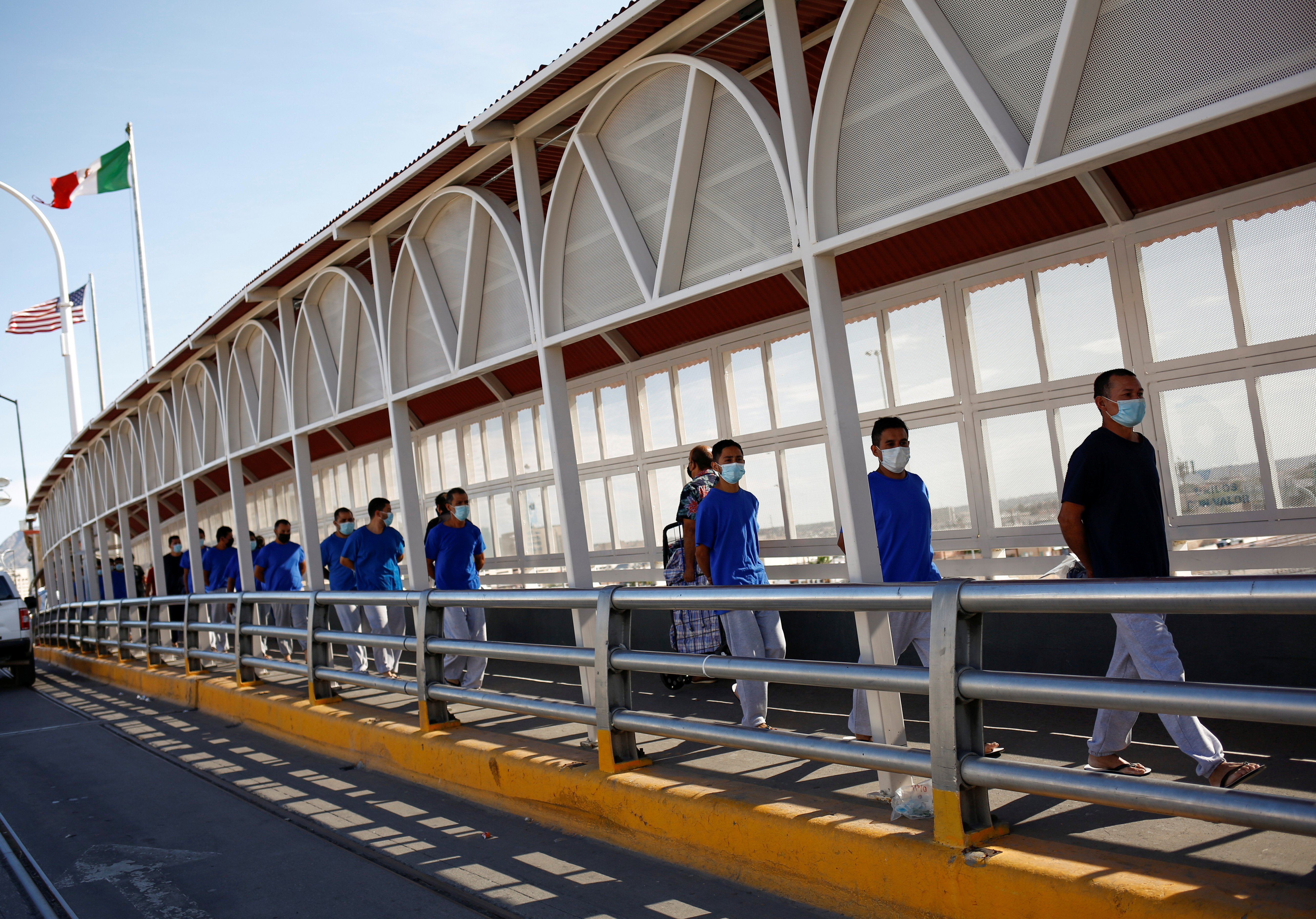 Migrants expelled from the U.S. and sent back to Mexico under Title 42 walk toward Mexico at the Paso del Norte International border bridge, in this picture taken from Ciudad Juarez, Mexico, July 29, 2021. (CNS photo/Jose Luis Gonzalez, Reuters)