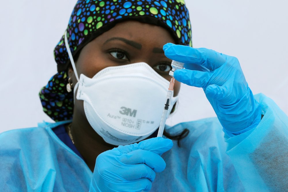 Registered nurse Sheba Phillip prepares a syringe with a dose of the Pfizer-BioNTech COVID-19 vaccine during a vaccination event for local adolescents and adults outside the Bronx Writing Academy school June 4 in New York City. (CNS/Reuters/Mike Segar)