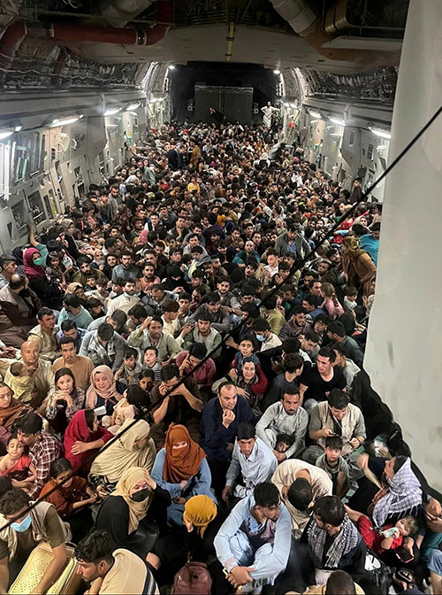 Evacuees crowd the interior of a U.S. Air Force C-17 Globemaster III transport aircraft carrying nearly 700 Afghans from Kabul to Qatar Aug. 15. (CNS/Courtesy of Defense One handout via Reuters)