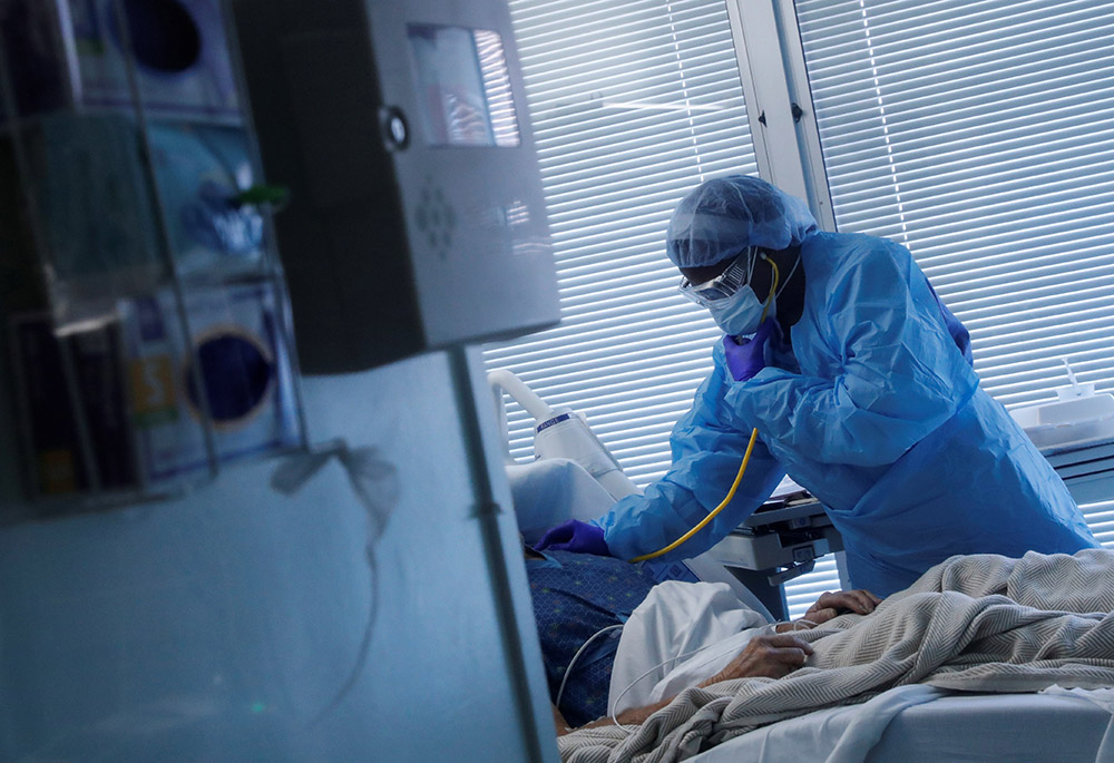 A registered nurse in Little Rock, Arkansas, checks on a COVID-19 patient Aug. 16, 2021, at the University of Arkansas for Medical Sciences. (CNS/Reuters/Shannon Stapleton) A registered nurse in Little Rock, Arkansas, checks on a COVID-19 patient Aug. 16, 2021, at the University of Arkansas for Medical Sciences. (CNS/Reuters/Shannon Stapleton)