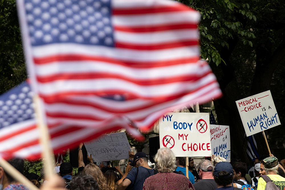 People are seen outside New York City Hall in Manhattan during a protest against mandating COVID-19 vaccines Aug. 16. (CNS/Reuters/Jeenah Moon)