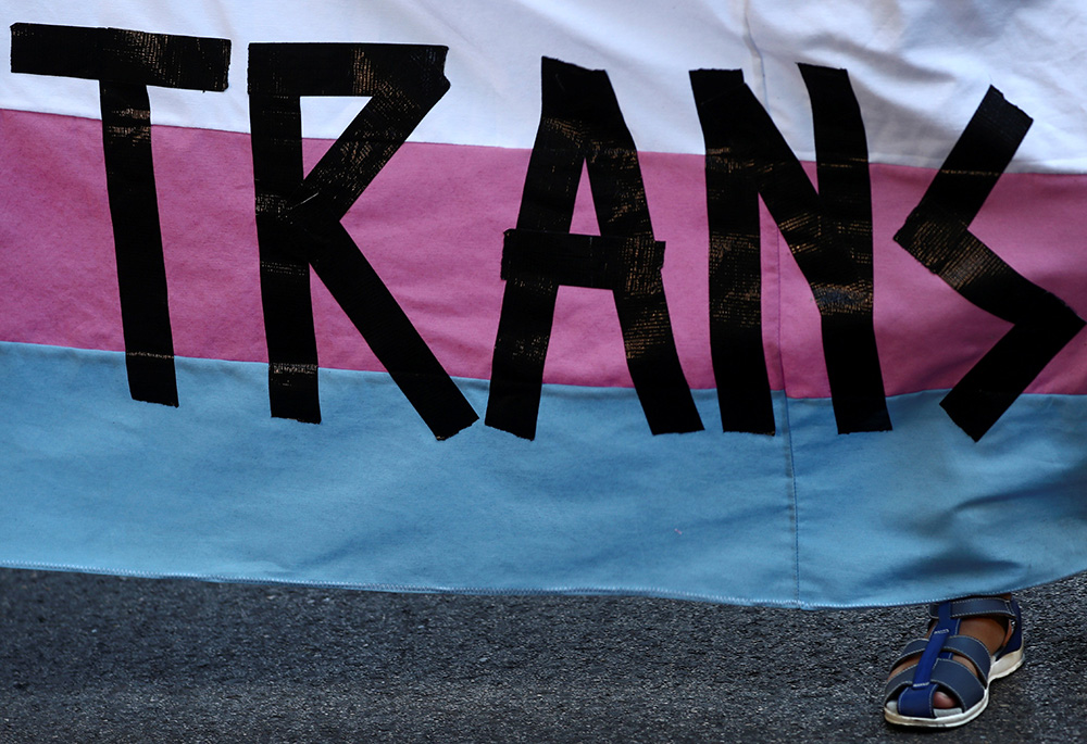A person holds a "Trans" banner in this illustration photo. (CNS/Reuters/Sergio Perez) A person holds a "Trans" banner in this illustration photo. (CNS/Reuters/Sergio Perez)