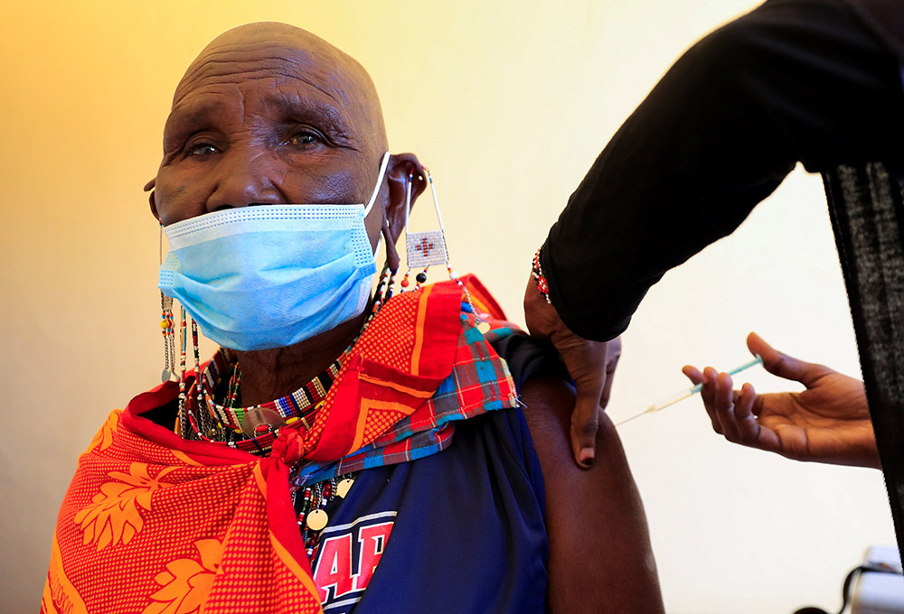 A member of the Indigenous Maasai community receives the COVID-19 vaccine at a health center near Nairobi, Kenya, Aug. 23. (CNS/Reuters/Thomas Mukoya)