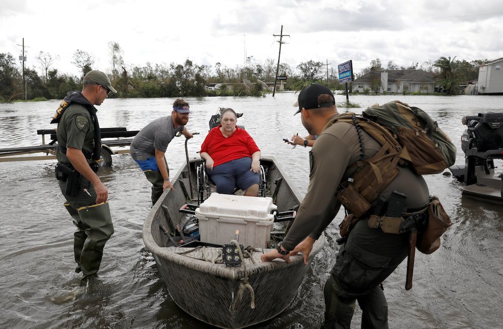 Members of a rescue team in Laplace, Louisiana, help evacuate people Aug. 30, after Hurricane Ida made landfall. (CNS photo/Marco Bello, Reuters)