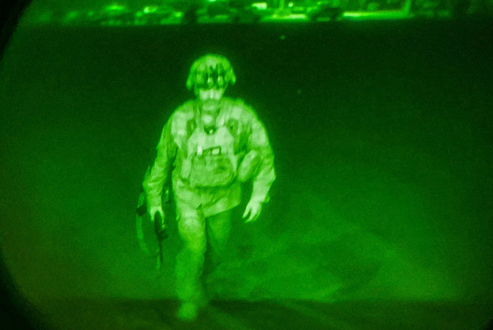 U.S. Army Maj. Gen. Chris Donahue, commander of the 82nd Airborne Division, steps on board a transport plane as the last U.S. service member to leave Kabul, Afghanistan, Aug. 30, in a photo taken via night vision optics. (CNS/XVIII Airborne Corps/Reuters)