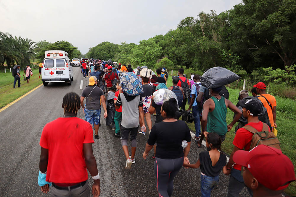 Migrants from Central America and the Caribbean walk in a caravan near Escuintla, Mexico, Aug. 29. They were headed to Mexico City to apply for asylum and refugee status. (CNS/Reuters/Jose Torres)