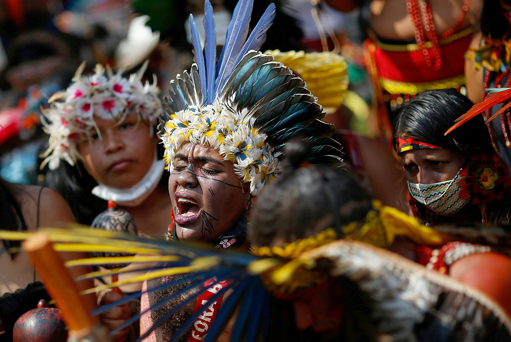 Brazilian Indigenous people march to protest President Jair Bolsonaro Brazilian Indigenous people take part in the second march of Indigenous women to protest President Jair Bolsonaro Sept. 10 in Brasilia. (CNS photo/Reuters/Adriano Machado)