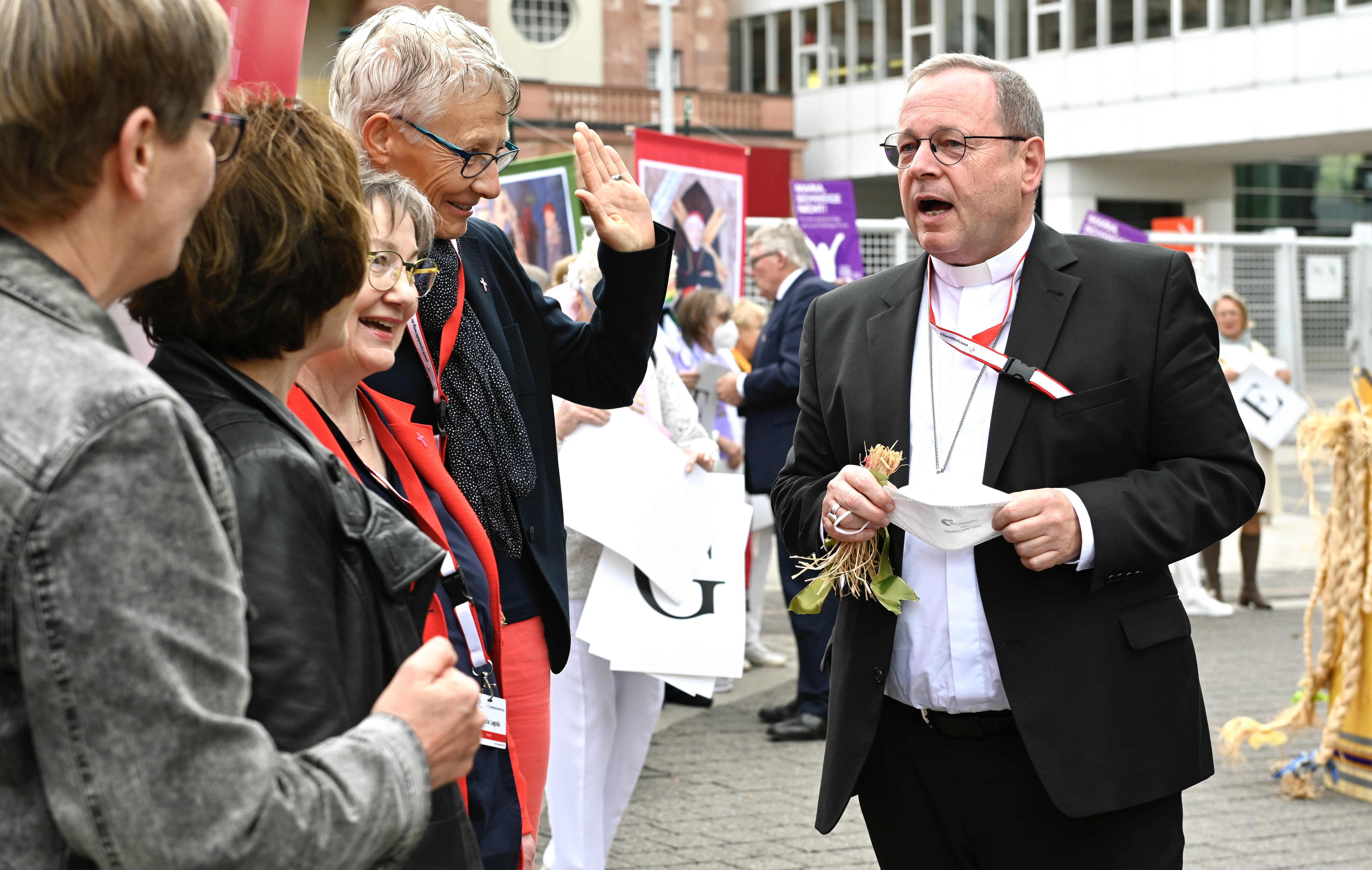 Bishop Georg Bätzing, president of the German bishops' conference, talks with protesters from Maria 2.0 and We Are Church outside the second Synodal Assembly in Frankfurt, Germany, Sept. 30, 2021. (CNS photo/Julia Steinbrecht, KNA)