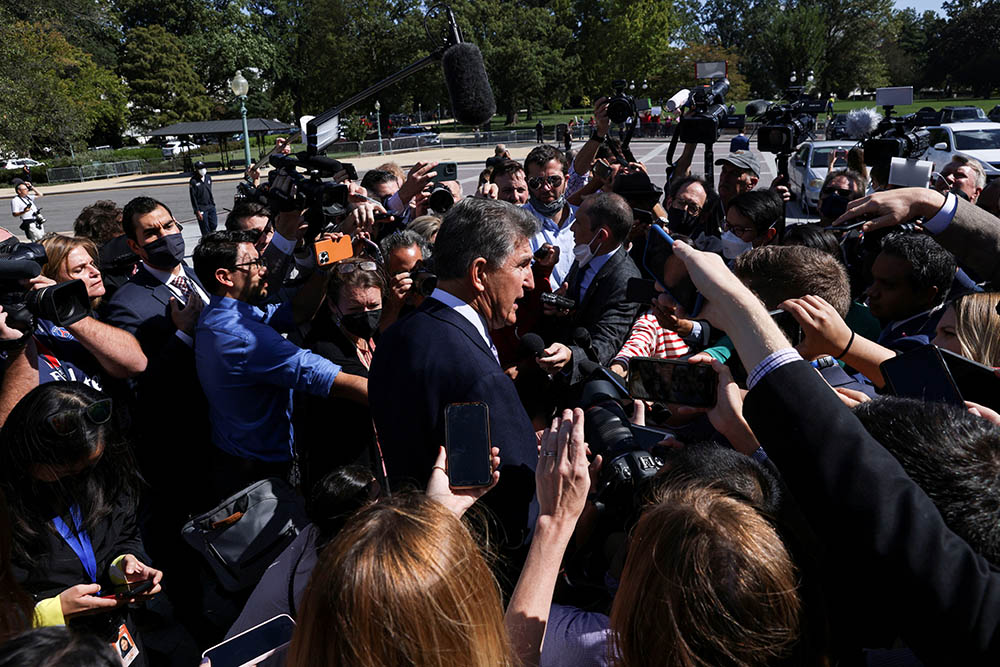 Sen. Joe Manchin, D-West Virginia, makes his way through a crowd of Capitol Hill reporters outside the U.S. Capitol in Washington Sept. 30, 2021. (CNS/Reuters/Leah Millis)