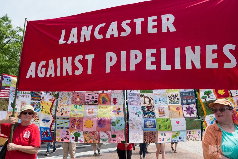 Activists with Lancaster Against Pipelines carry a banner during a 2017 climate march in Washington. A federal court judge has dismissed a lawsuit filed by the Adorers of the Blood of Christ, a religious order that has been challenging construction of a n