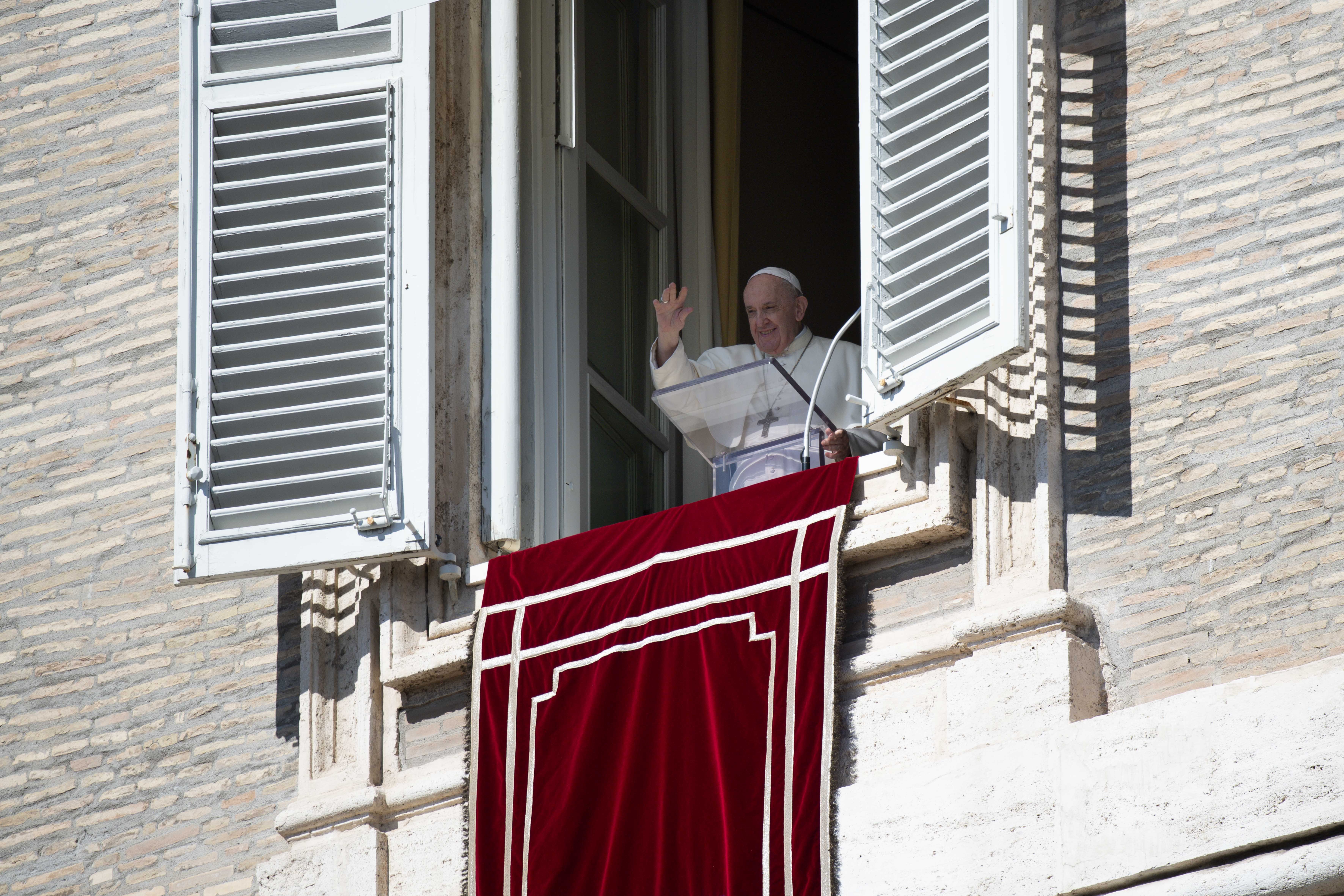 Pope Francis greets the crowd as he leads the Angelus from the window of his studio overlooking St. Peter's Square at the Vatican Oct. 10, 2021. (CNS photo/Vatican Media)