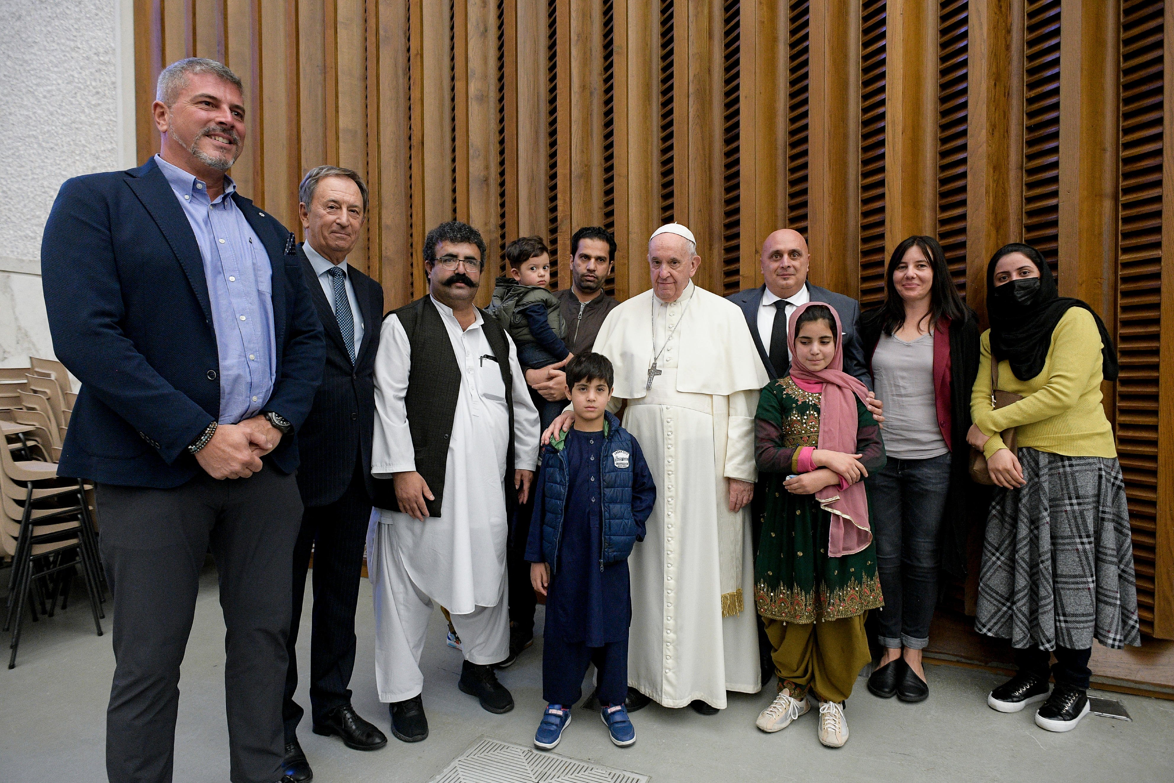 Pope Francis meets family members who fled from Afghanistan, during his general audience in the Paul VI hall at the Vatican Oct. 13, 2021. (CNS photo/Vatican Media)