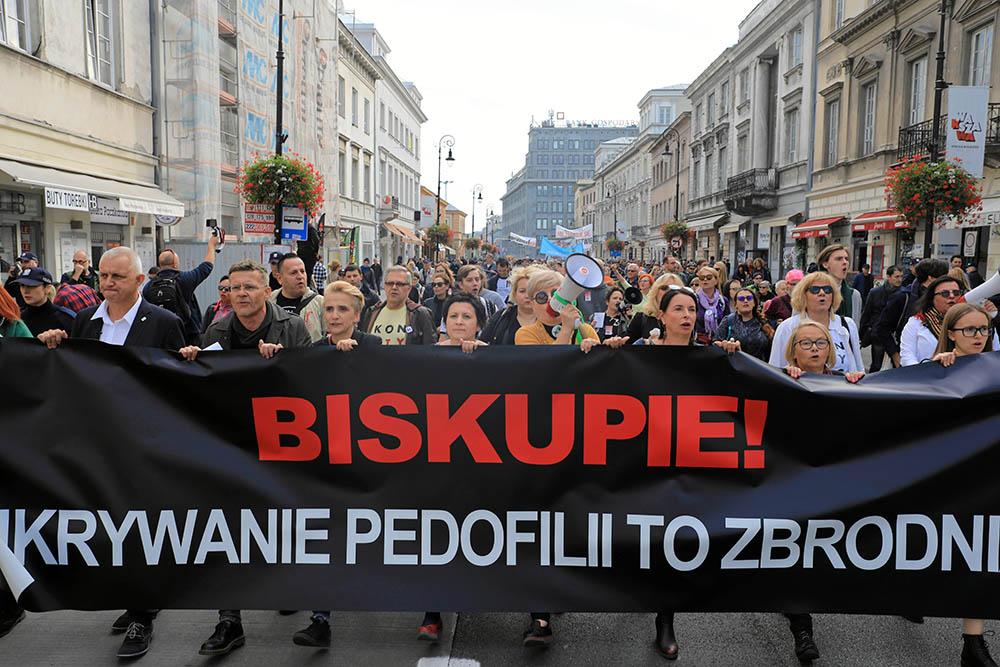 People take part during a demonstration against pedophilia, "Hands away from children," in Warsaw, Poland, Oct. 7, 2018. The banner reads, "Bishop, hiding pedophilia is a crime." (CNS/Agencja Gazeta via Reuters/Jacek Marczewski)