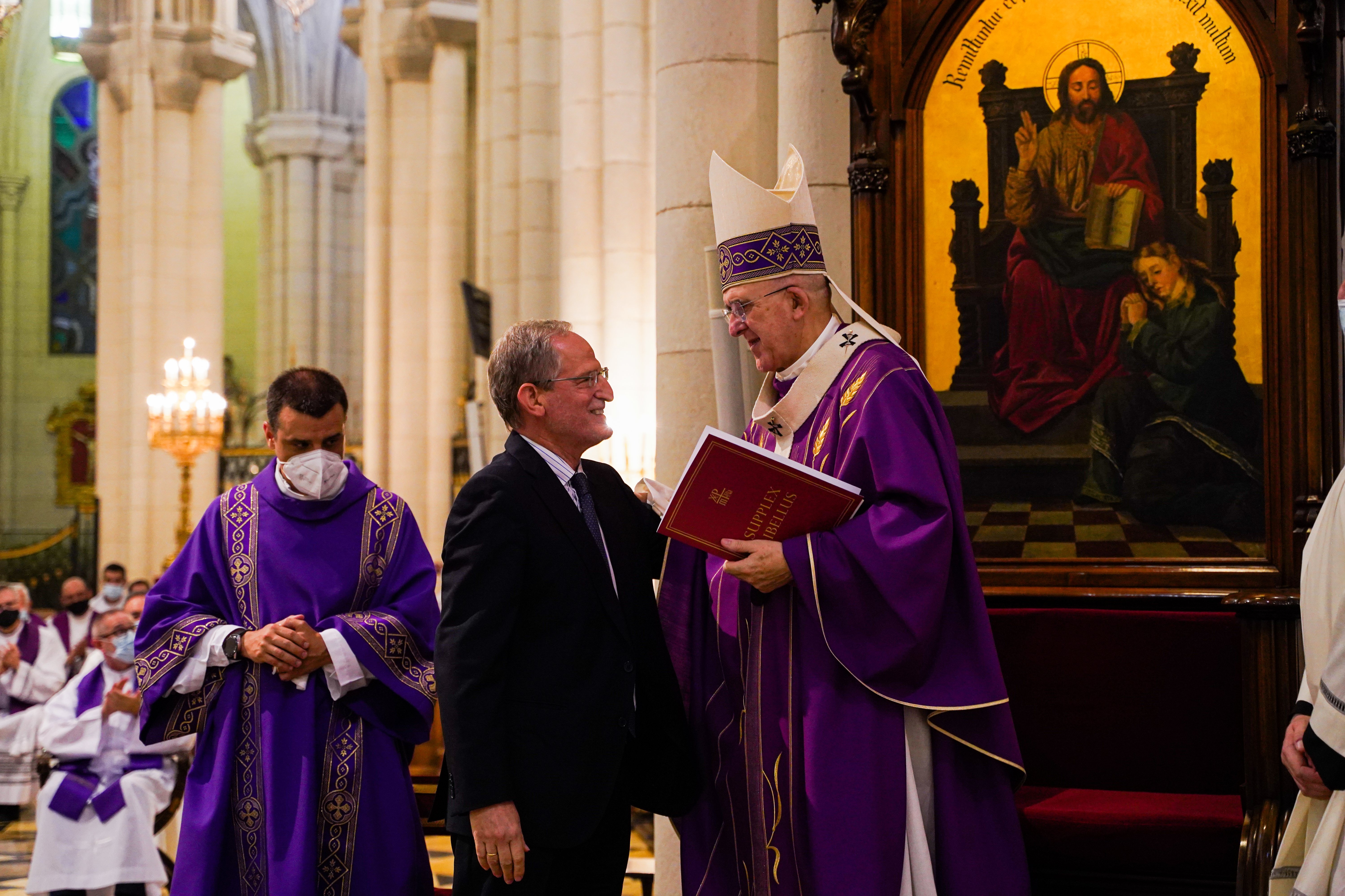 Carlos Metola, postulator of the sainthood cause of Carmen Hernández, presents to Cardinal Carlos Osoro Sierra of Madrid the written request that the sainthood process for her be formally opened, during a Mass in the cathedral in Madrid July 19, 2021. (CN
