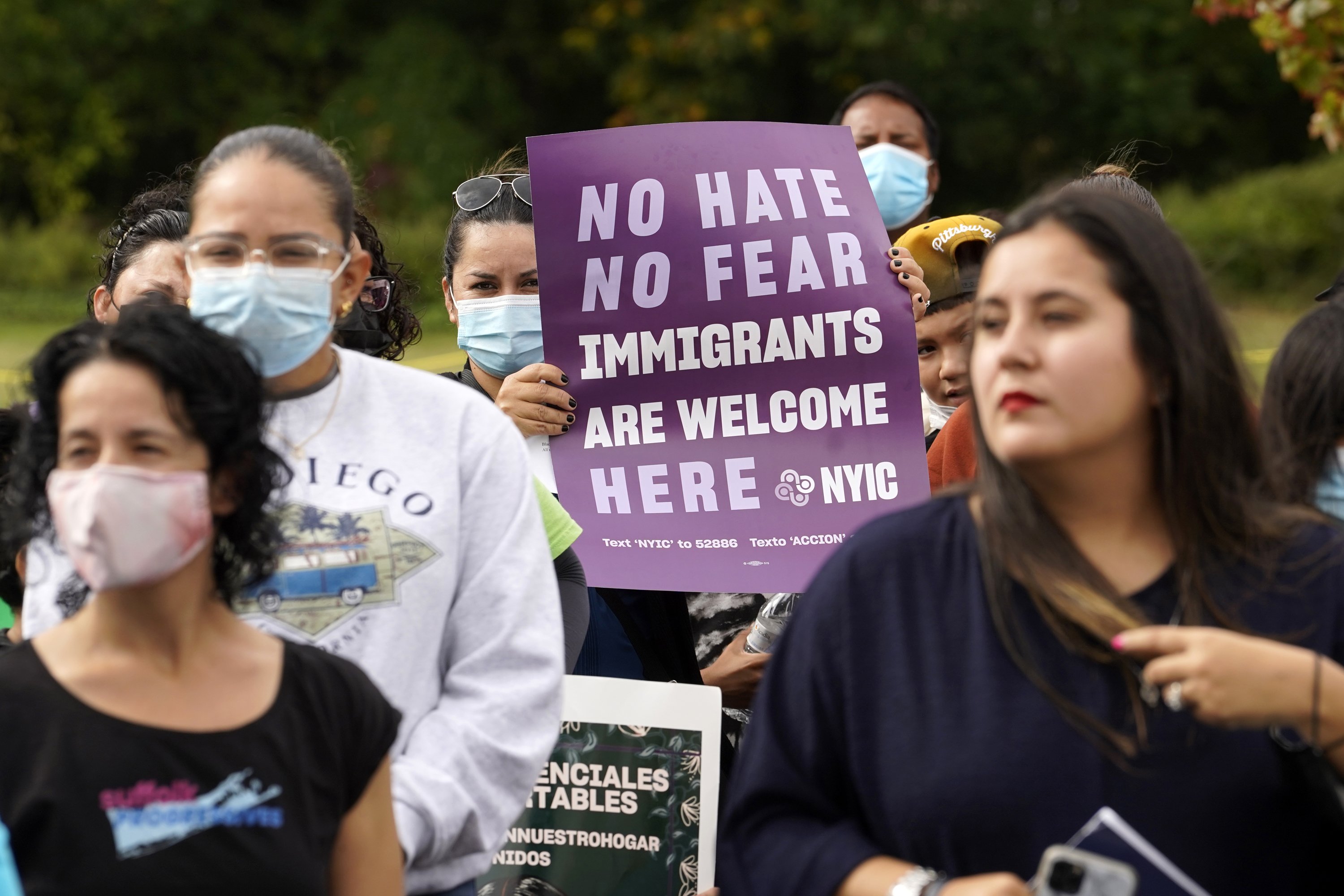 A woman holds a sign during a march and rally in support of immigration reform Oct. 16, 2021. (CNS photo/Gregory A. Shemitz)