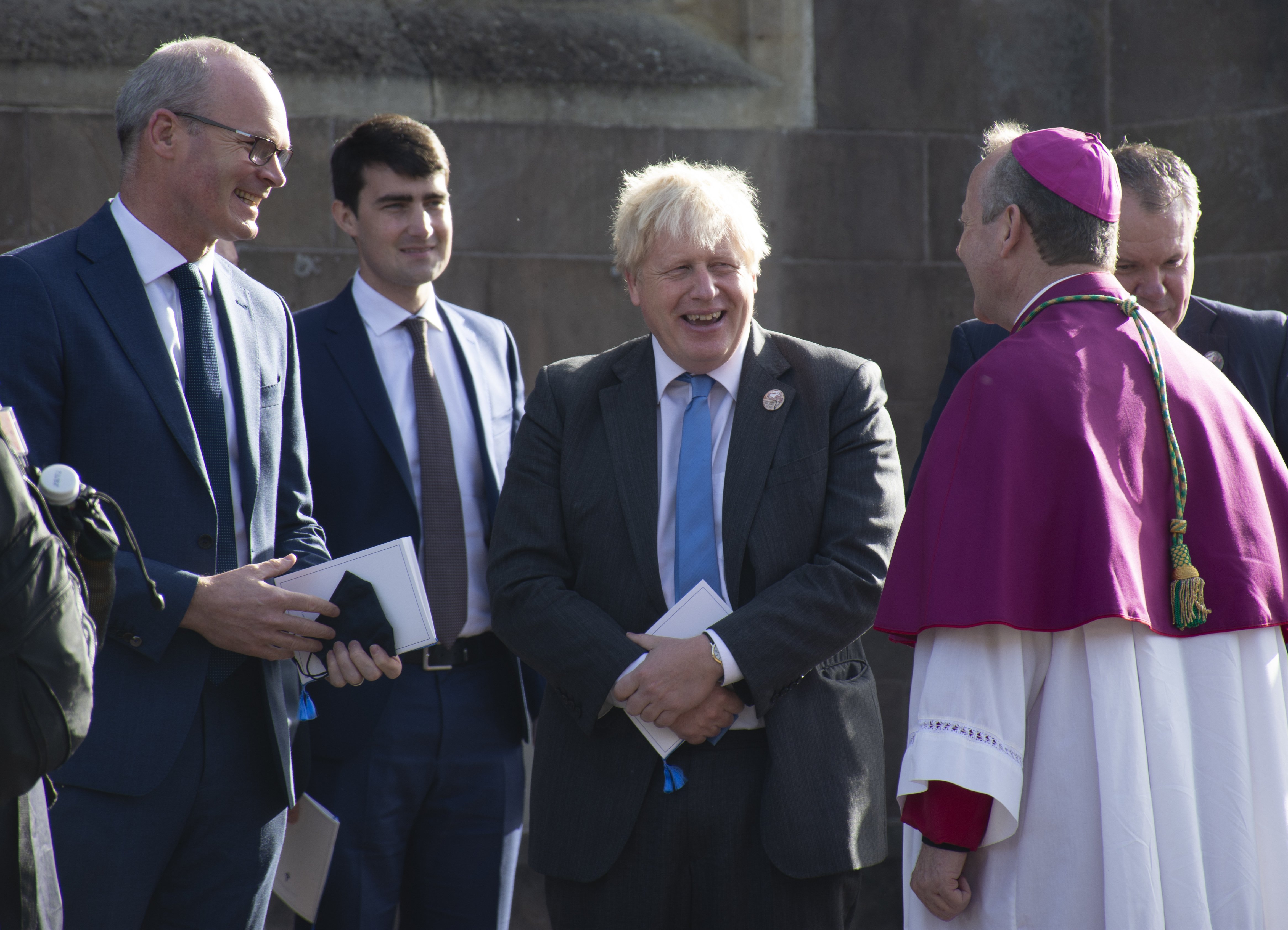 Archbishop Eamon Martin of Armagh, Northern Ireland, speaks with Irish Foreign Affairs Minister Simon Coveney, far left, and British Prime Minister Boris Johnson following a service to mark the centenary of the partition of Ireland in Armagh Oct. 21, 2021