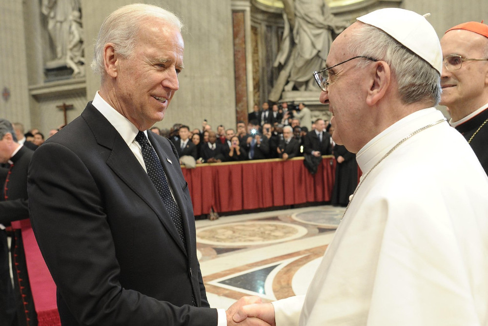 Pope Francis greets then-U.S. Vice President Joe Biden in St. Peter's Basilica at the Vatican March 19, 2013, as the new pontiff receives dignitaries following his inaugural Mass. (CNS/Vatican Media)