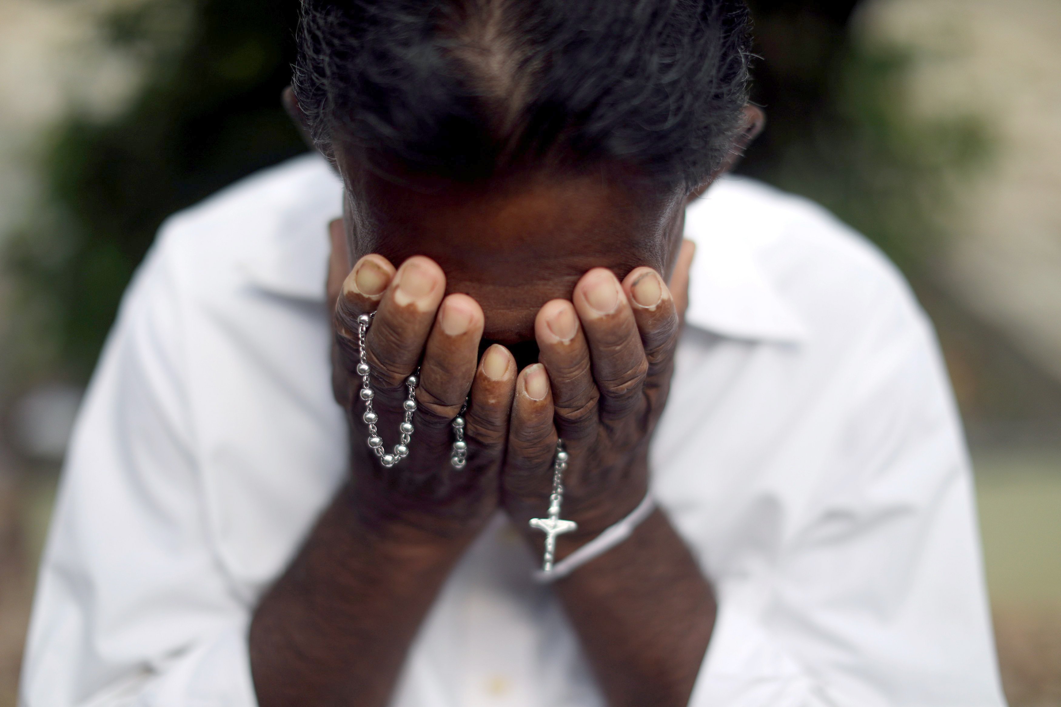 A person mourns near the grave of a suicide bombing victim at Sellakanda Catholic cemetery in Negombo, Sri Lanka, April 23, 2019. (CNS photo/Athit Perawongmetha, Reuters)