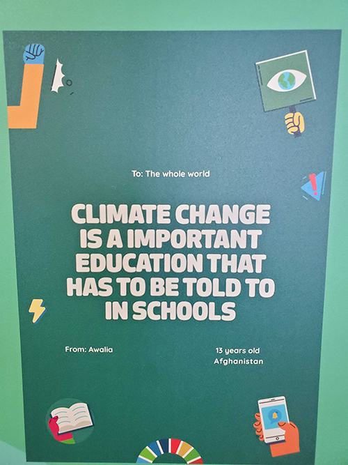 Signs displayed in the COP26 Blue Zone, the main site of the U.N. climate conference, share messages from children across the globe to world leaders on the importance of education about climate change. (EarthBeat photo/Brian Roewe)