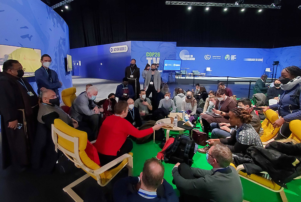 Members of various Catholic organizations meet inside the Action Zone at the COP26 United Nations climate change conference Nov. 2 in Glasgow, Scotland. (EarthBeat photo/Brian Roewe)