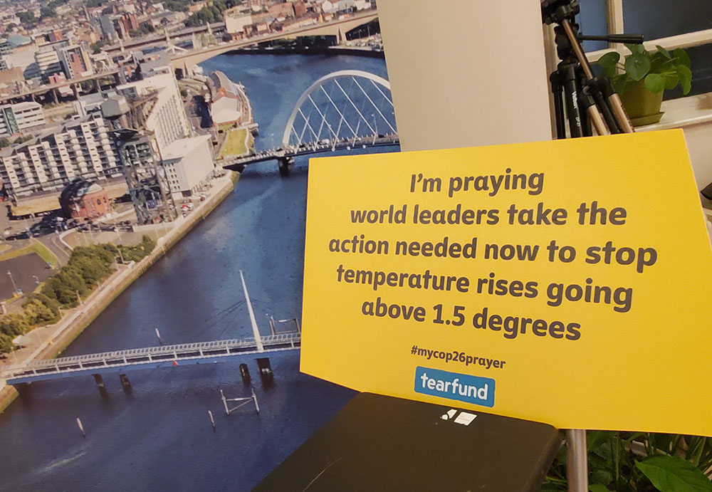 A sign displaying a prayer message for the U.N. climate change conference, COP26, is seen at an interfaith climate event at St. George's Tron Church Nov. 2, 2021, in central Glasgow, Scotland. (NCR photo/Brian Roewe)
