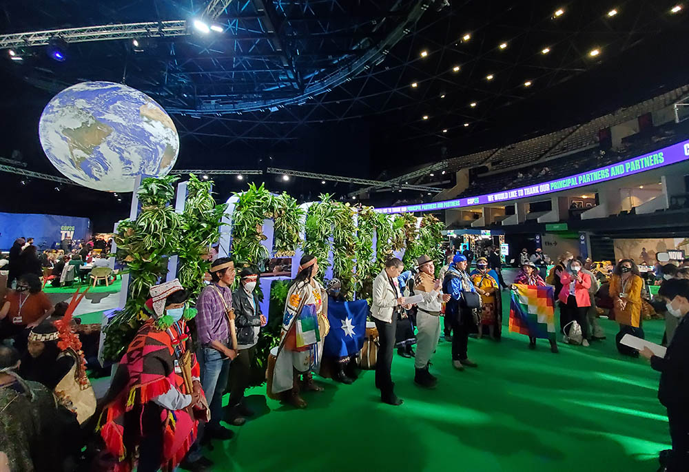 Members of the Minga Indígena, a collective of Indigenous communities throughout the American continents, address the media in the Blue Zone, the main arena for negotiations at the COP26 U.N. climate summit on Nov. 3, 2021. (NCR photo/Brian Roewe)