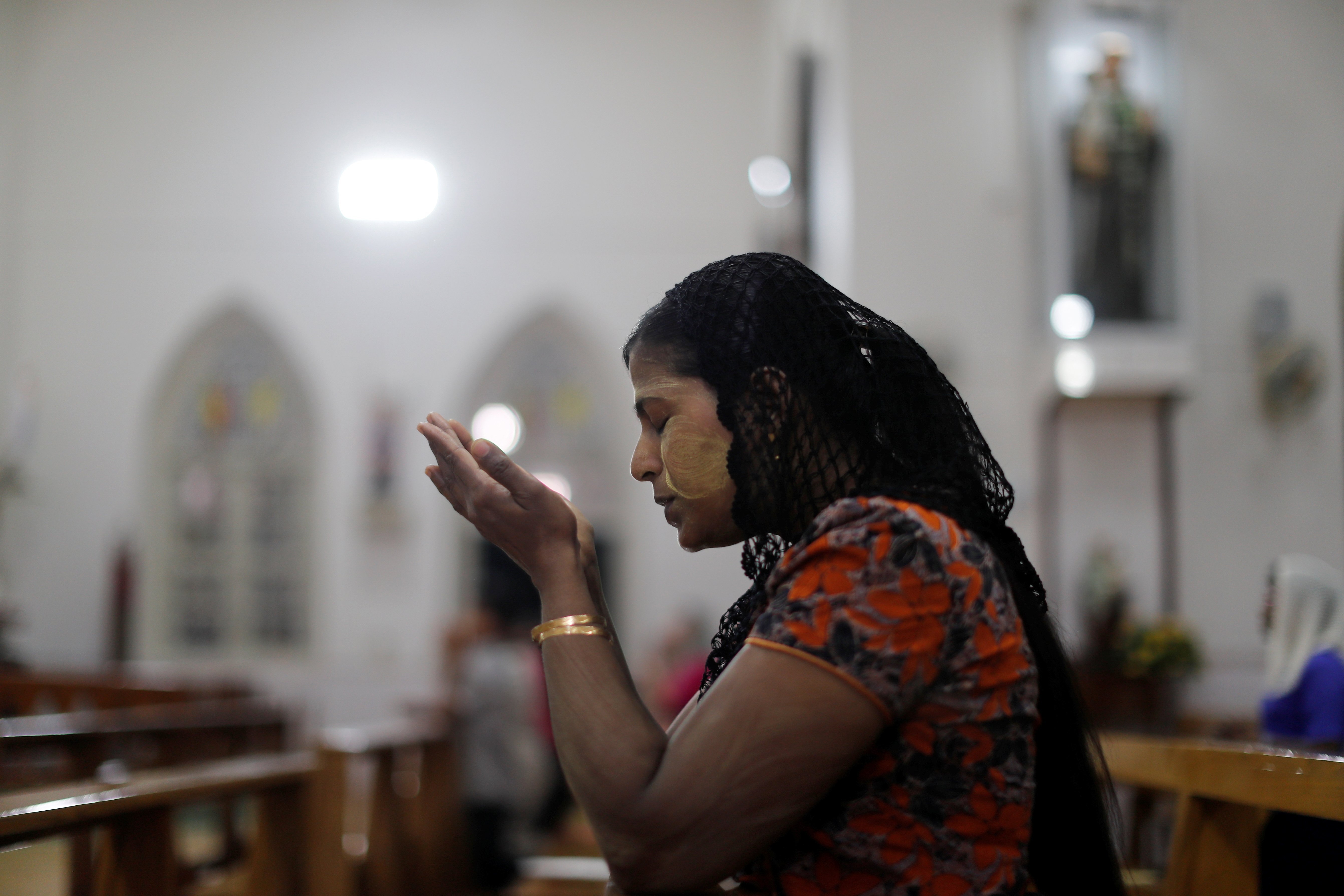 A woman is pictured in a file photo praying at St. Anthony Church in Yangon, Myanmar, Nov. 28, 2017. (CNS photo/Jorge Silva, Reuters)