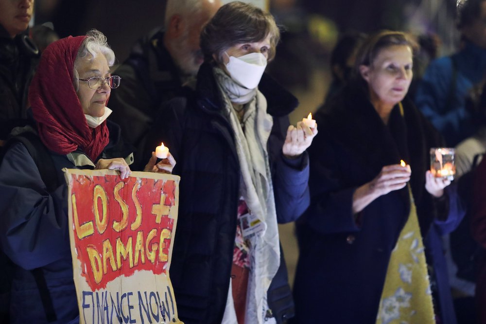 People hold candles as they take part in a vigil outside the U.N. Climate Change Conference Nov. 10 in Glasgow, Scotland. (CNS/Reuters/Russell Cheyne)