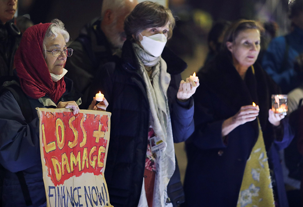 People hold candles as they take part in a vigil outside the U.N. Climate Change Conference in Glasgow, Scotland, Nov. 10, 2021. (CNS/Reuters/Russell Cheyne)