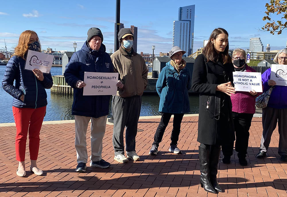 Sarah Pearson, in black coat, was part of a group of sex abuse survivors who called on U.S. bishops, in a Nov. 16 press conference in Baltimore, to focus less on who can take Communion and instead do more about sex abuse.
