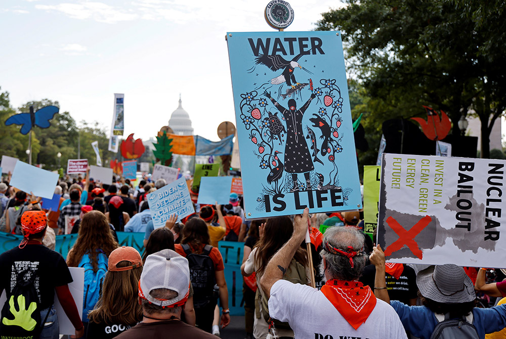 Environmental activists march to the U.S. Capitol during a climate change protest Oct. 15 in Washington. (CNS/Reuters/Jonathan Ernst)