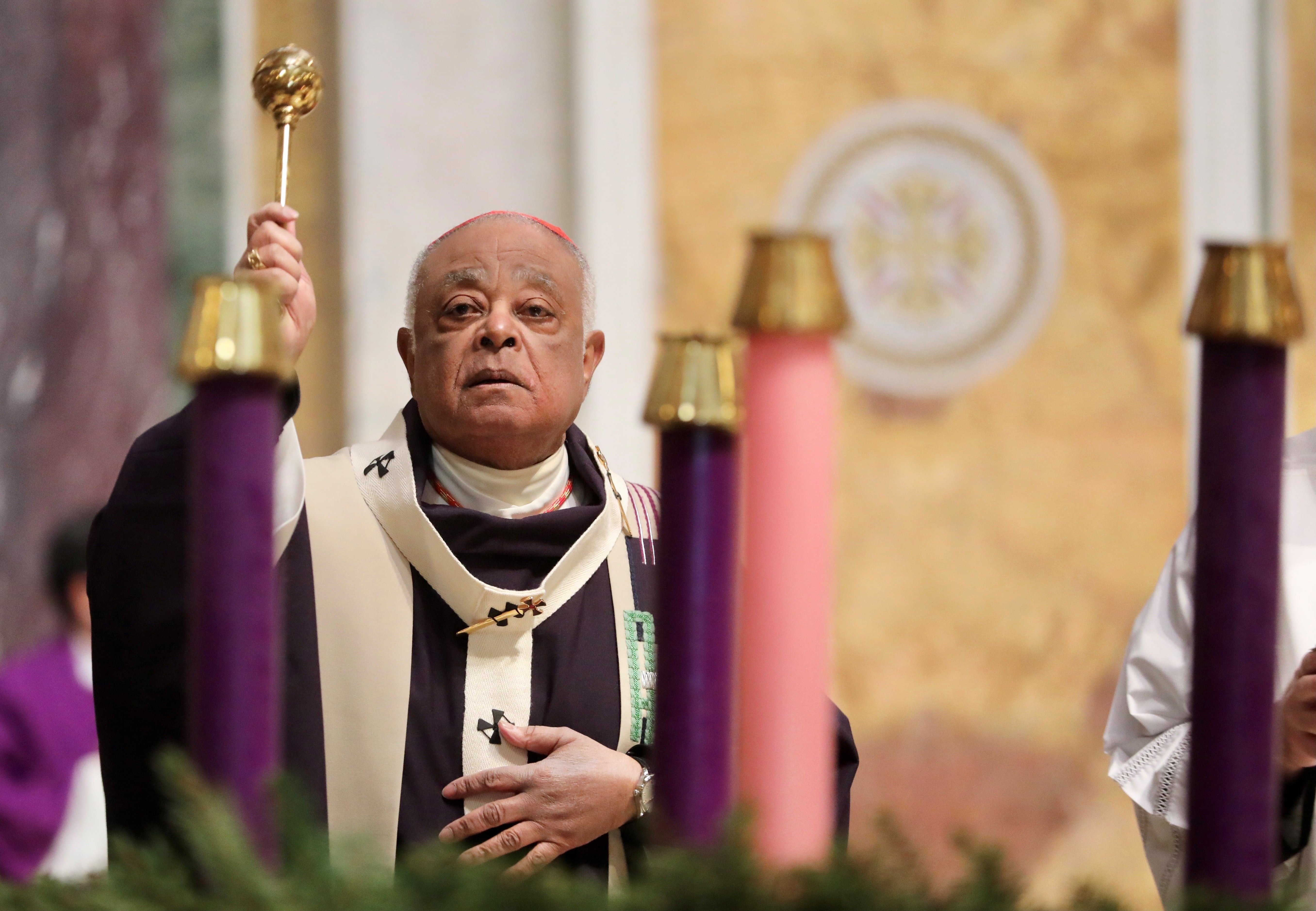 Washington Cardinal Wilton D. Gregory sprinkles holy water to bless the Advent wreath during Mass at St. Matthew's Cathedral Nov. 28, 2021, the first Sunday of Advent. (CNS photo/Andrew Biraj, Catholic Standard)