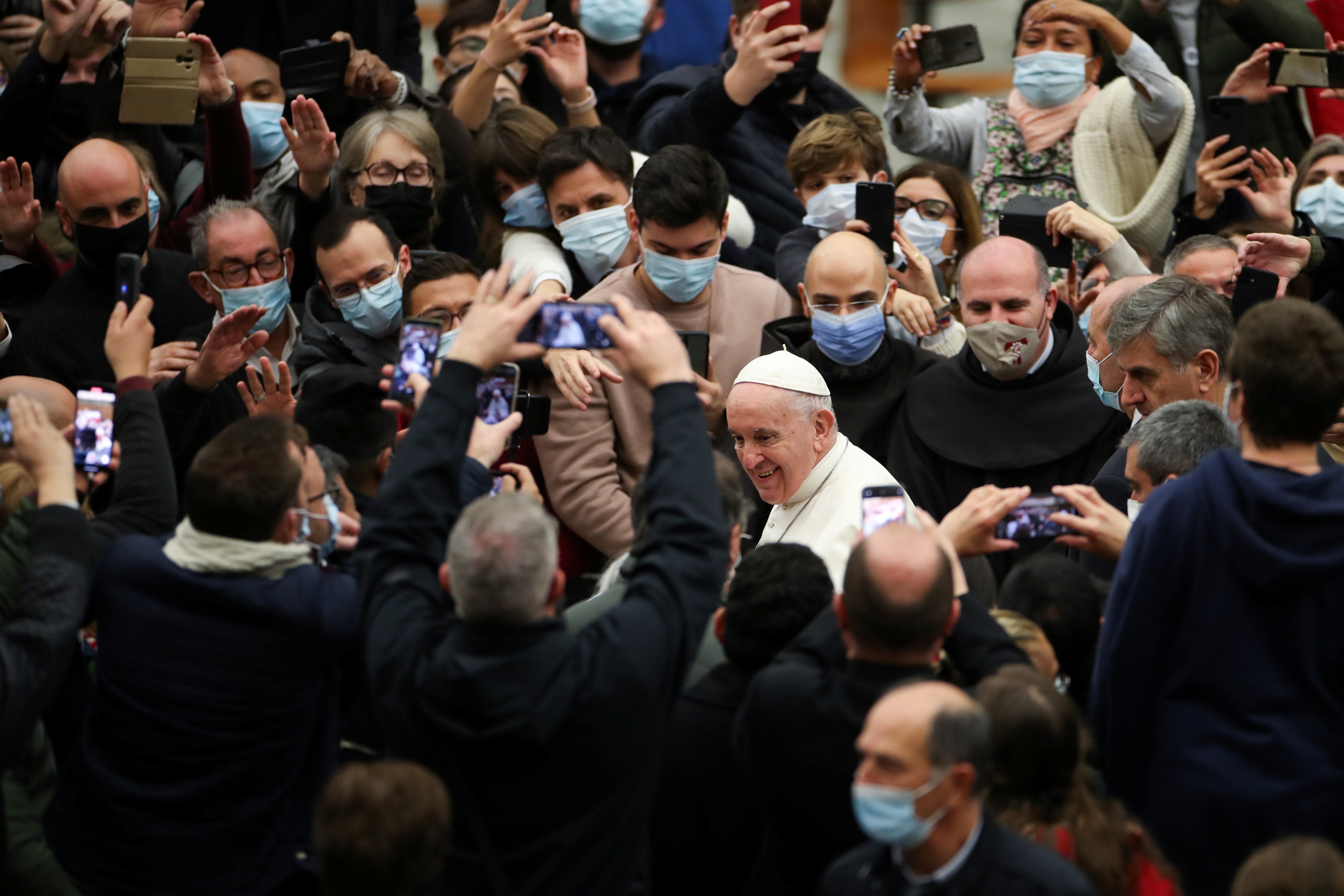 Pope Francis walks through the crowd after his general audience in Paul VI hall at the Vatican Dec. 1, 2021. (CNS photo/Yara Nardi, Reuters)