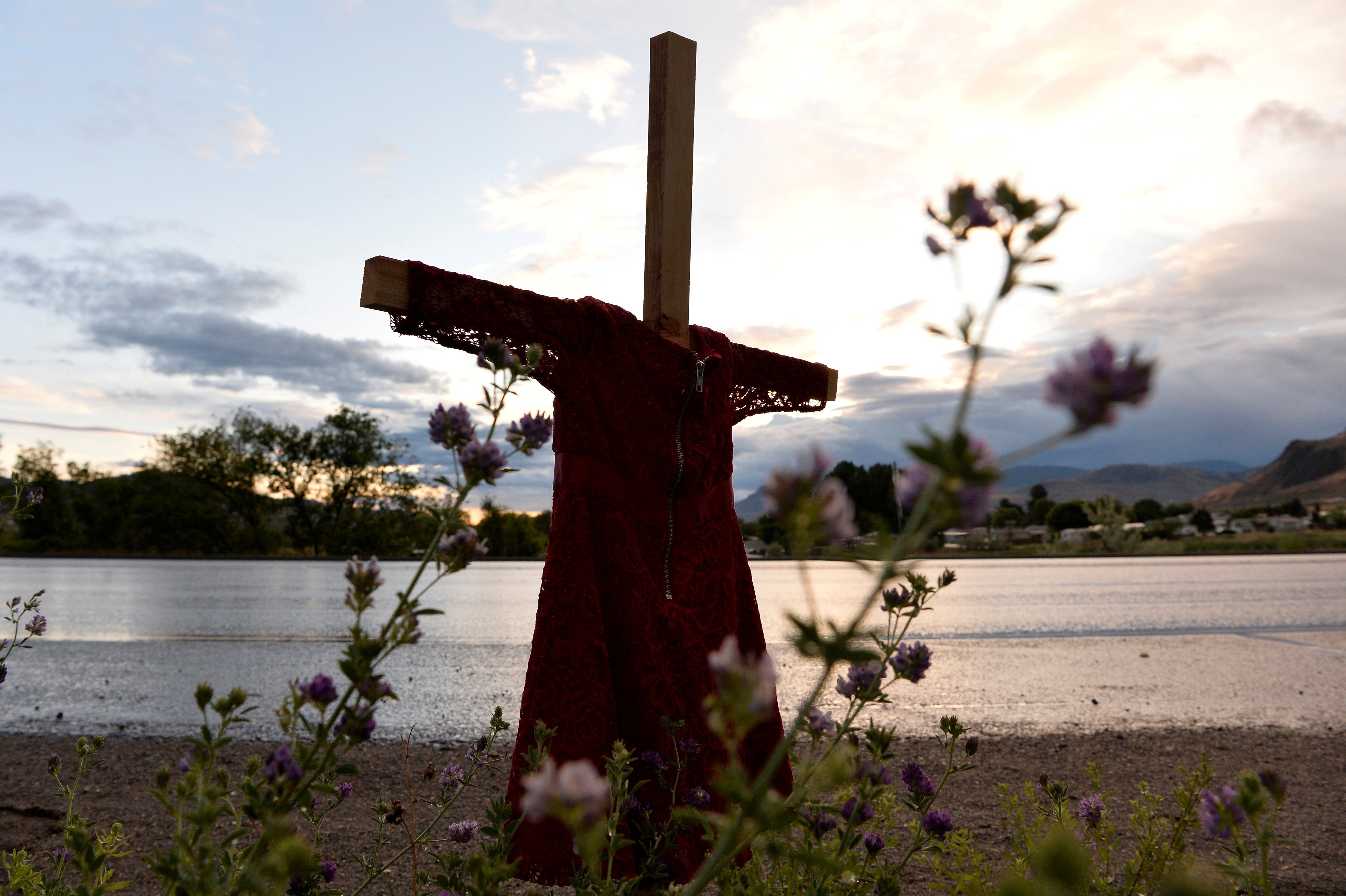 A child's red dress hangs on a stake near the grounds of the former Kamloops Indian Residential School in Kamloops, British Columbia, June 5, 2021. (CNS photo/Jennifer Gauthier, Reuters)