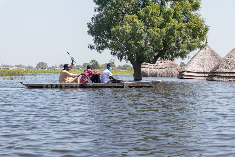 South Sudanese men navigate a canoe through floodwaters in Bentiu Nov. 20. Bishop Stephen Nyodho Ador Majwok of Malakal called for support as floods continued to devastate his diocese. (CNS photo/Njiiri Karago/Medecins Sans Frontieres handout via Reuters)