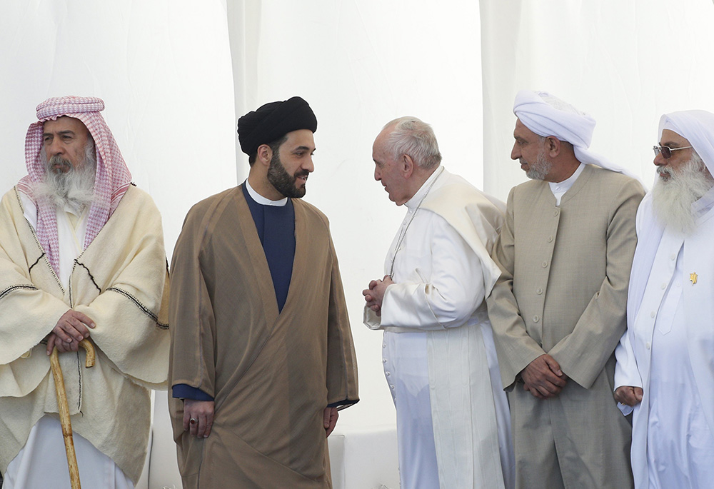 Pope Francis talks with a religious leader during an interreligious meeting on the plain of Ur near Nasiriyah, Iraq, March 6. Despite security and COVID-19 risks, the pope completed a successful visit to Iraq. (CNS/Paul Haring)