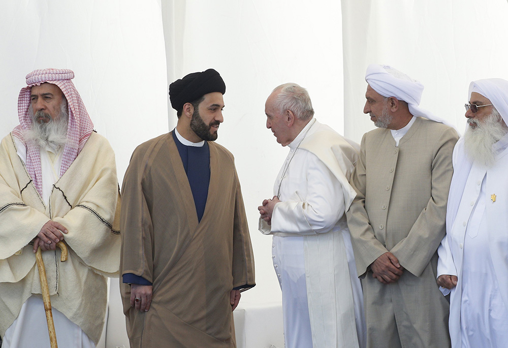 Pope Francis talks with a religious leader during an interreligious meeting on the plain of Ur near Nasiriyah, Iraq, March 6. Despite security and COVID-19 risks, the pope completed a successful visit to Iraq. (CNS/Paul Haring) Pope Francis talks with a religious leader during an interreligious meeting on the plain of Ur near Nasiriyah, Iraq, March 6. Despite security and COVID-19 risks, the pope completed a successful visit to Iraq. (CNS/Paul Haring)