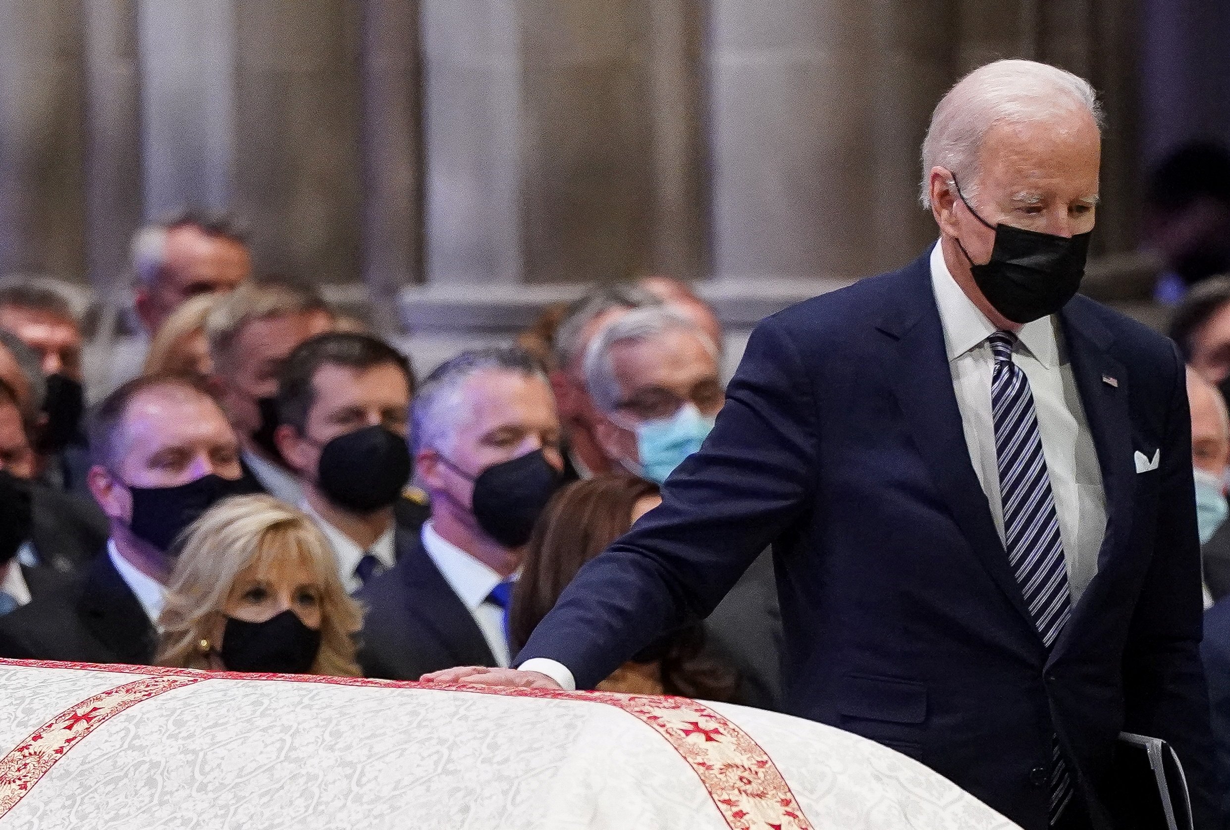 President Joe Biden touches the casket of the late Senate Majority Leader Bob Dole, R-Kan., at the National Cathedral in Washington as he walks up to speak during a Dec. 10, 2021, funeral service. (CNS photo/Kevin Lamarque, Reuters)