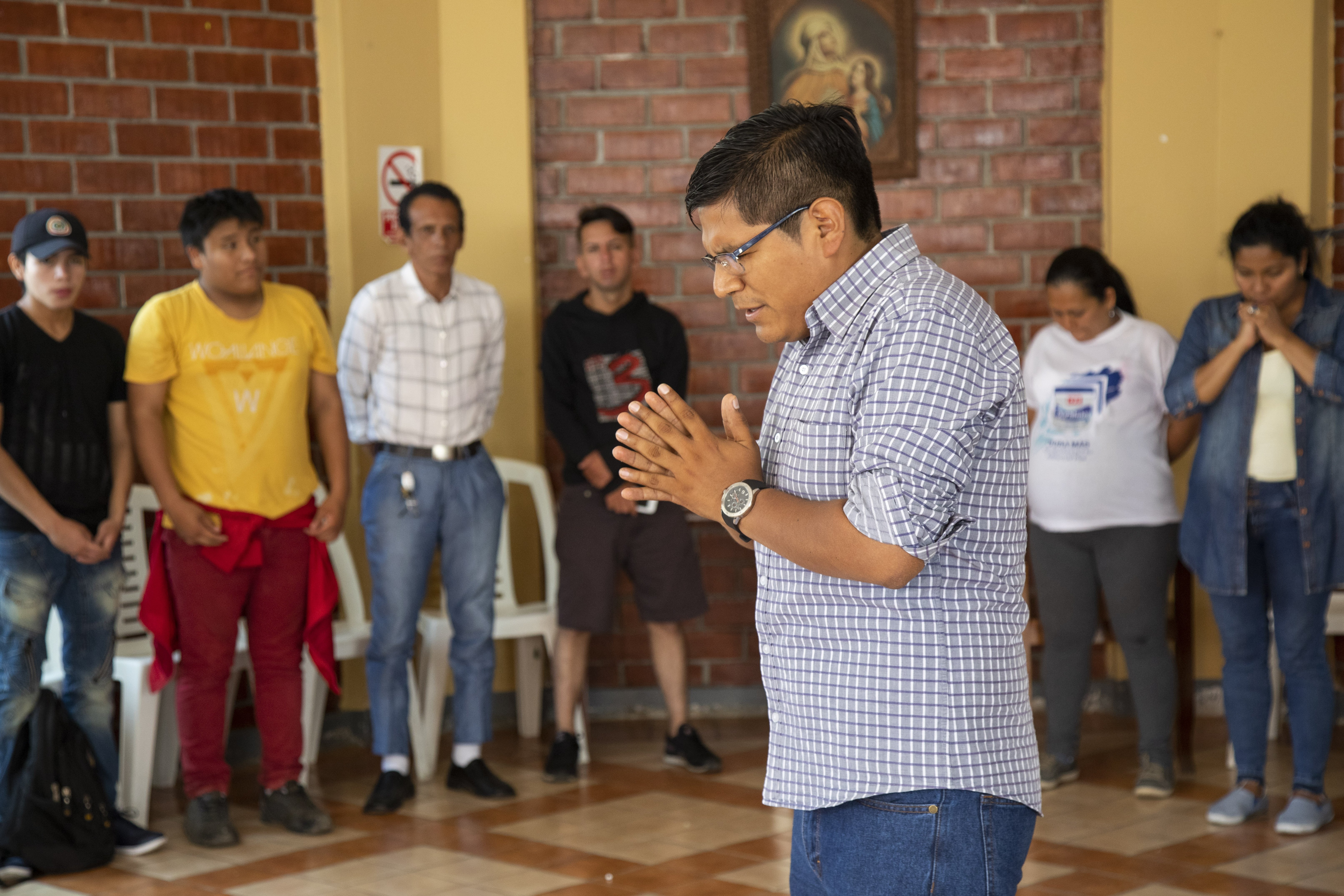 Abraham Luque, a catechist from the Scalabrinian Parish of Our Lady of the Perpetual Help, prays during a Christmas event at the Scalabrini welcome center in Lima, Peru, in this Dec. 16, 2018, file photo.  (CNS photo/Oscar Durand)