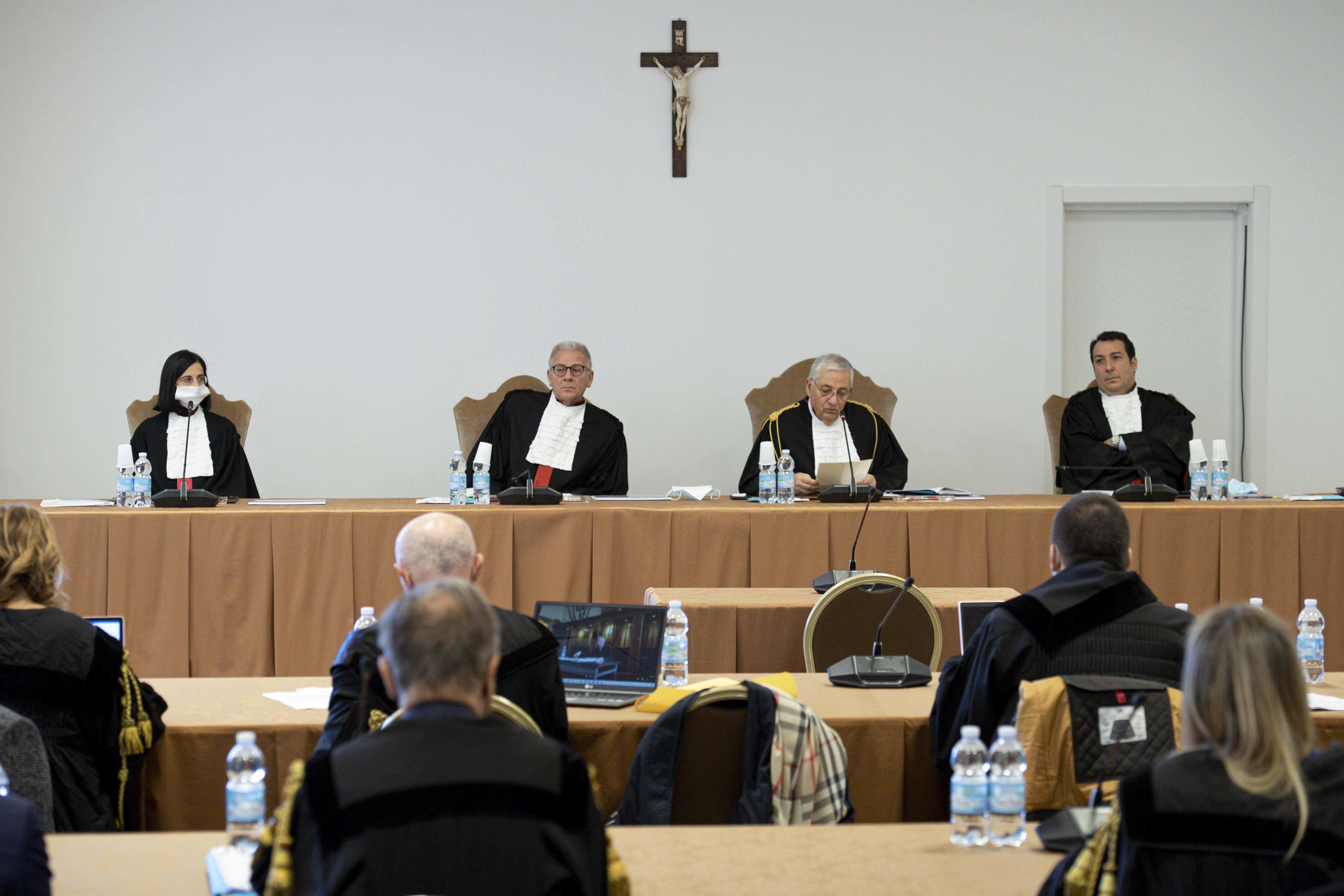 Vatican judges preside over the third session of the trial of six defendants accused of financial crimes, including Cardinal Angelo Becciu, at the Vatican City State criminal court in this Nov. 17, 2021. Pictured from left are judges Lucia Bozzi, Venerand