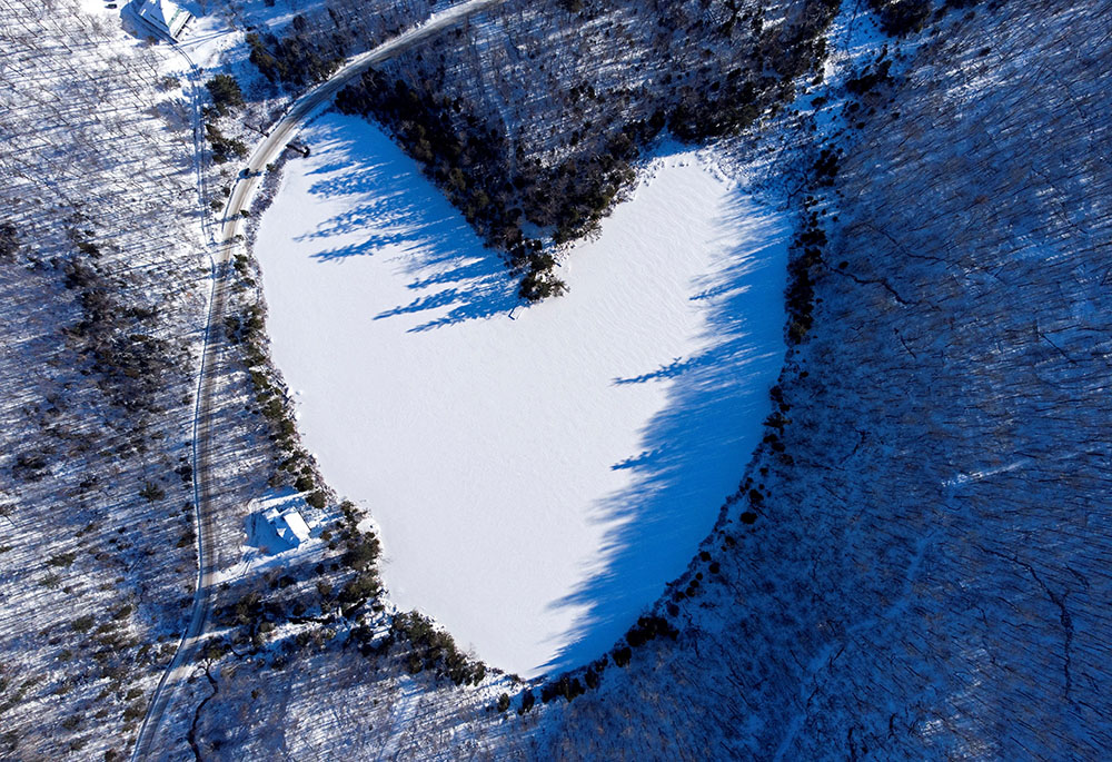 Snow in East Bolton, Quebec, covers the heart-shaped and frozen Baker Pond Dec. 24, 2021. (CNS/Reuters/Bernard Brault) Snow in East Bolton, Quebec, covers the heart-shaped and frozen Baker Pond Dec. 24, 2021. (CNS/Reuters/Bernard Brault)