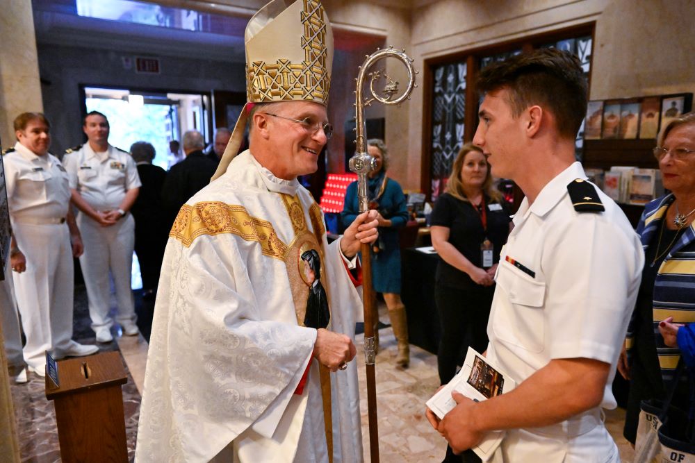 Archbishop Timothy Broglio of the U.S. Archdiocese for the Military Services greets a U.S. Naval Academy cadet midshipman after the annual Sea Services Pilgrimage Mass at the National Shrine of St. Elizabeth Ann Seton in Emmitsburg, Md., Oct. 2, 2022. (CNS/Jason Minick, courtesy of Devine Partners)
